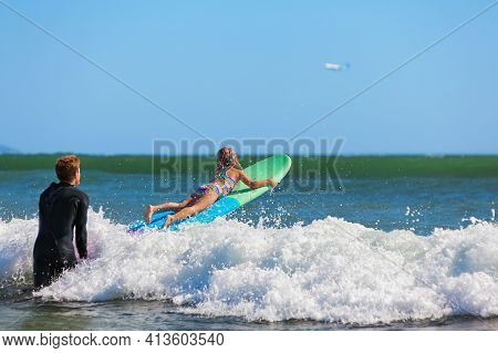 Little Surf Girl - Young Surfer Learn To Ride On Surfboard With Instructor At Surfing School. Active