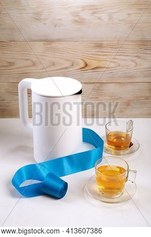 Tea Cup And Electric Kettle On White Table At Home In Wooden House