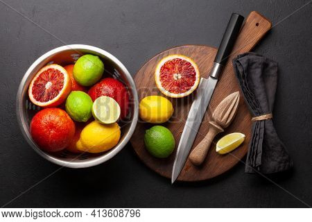Various fresh citrus fruits in colander. Bood orange, lime, lemon. Top view flat lay