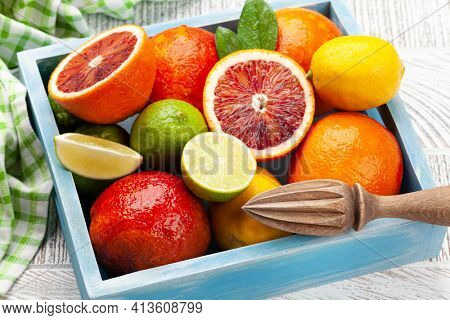 Various fresh citrus fruits in wooden box. Bood orange, lime, lemon