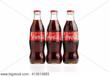 Estonia, Tallinn - 14.02.2021: Coca-cola Classic In A Glass Bottle Isolated On White. Three Bottles 