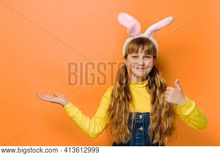 Close Up Head Shot Portrait Schoolgirl In Bunny Fluffy Ears. Cute Teenager Pointing Index Finger On 