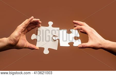 Closeup Hands Of Man Connecting Jigsaw Puzzle. Business Solutions, Success And Strategy Concept. Two