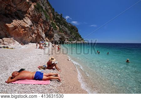 Konavle, Croatia - June 28, 2019: People Spend Vacation At Pasjaca Beach Below Cliffs In Konavle Reg