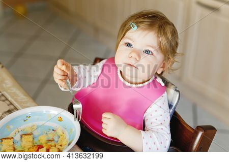 Adorable Baby Girl Eating From Spoon Mashed Vegetables And Puree. Food, Child, Feeding And People Co