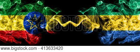 Ethiopia, Ethiopian Vs Gabon, Gabonese, Gabonian Smoky Mystic Flags Placed Side By Side. Thick Color