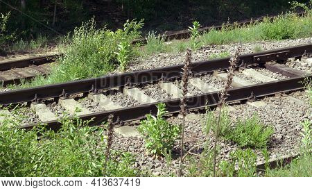 Railway Tracks On Concrete And Wood Sleepers. Jointed Track Made With Fishplates On 4-bolts. Metal R