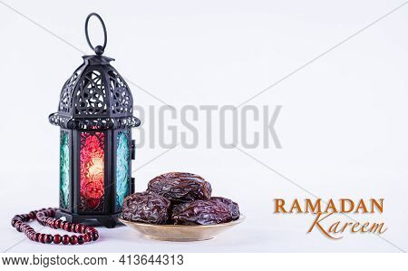 Ramadan Food And Drinks Concept. Ramadan Arabian Lamp, Wood Rosary, And Dates Fruit On White Backgro