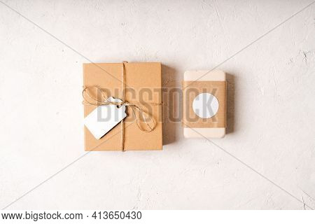 Soap And Craft Eco Gift Box Or Present Box With Bow On White Background With Mockup Label Tag. Copy 