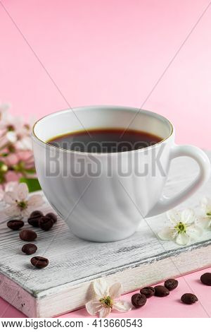 Cup Of Strong Espresso Coffee And Delicate Spring Flowers On Pink Background. Springtime And Good Mo