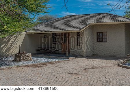 Okaukuejo, Namibia - January 14, 2020 : Okaukuejo Resort With Thatched Roof Houses And Campsite In E