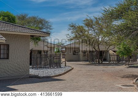 Okaukuejo, Namibia - January 14, 2020 : Okaukuejo Resort With Thatched Roof Houses And Campsite In E