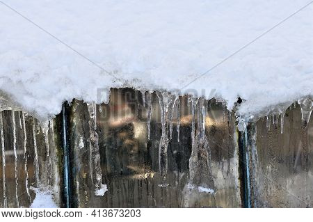 Detail Of Icicles Hanging From The Roof In Winter Garden