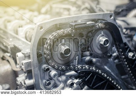 New Car Timing Chain On A Disassembled Diesel Old Engine In A Car Workshop. Close Up. Blur Effect.