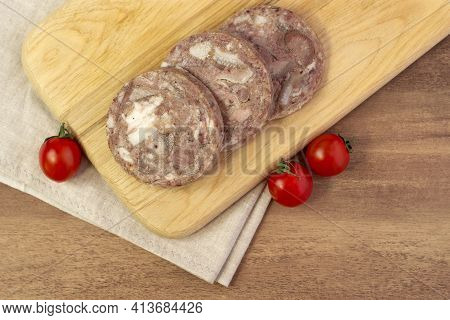 Homemade Brawn Headcheese Meat Product Saltison On Rough Linen Cloth With Cherry Tomatoes Top View
