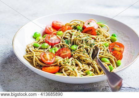 Green Vegan Edamame Pasta With Tomatoes And Beans. Plant Based Diet Concept.
