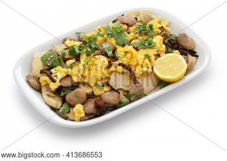 iraqi breakfast; boiled dried broad beans and scrambled eggs over pieces of flatbread