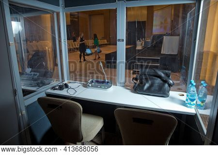Soft Focus Of Wireless Conference Microphones And Notebook In A Meeting Room. Translators Cubicle . 