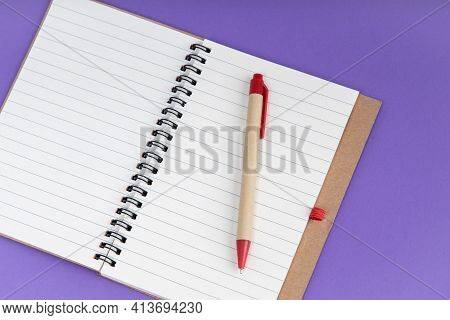 Set Of Recycle Paper Notebook And Pen. Open Diary Notebook On Prple Background