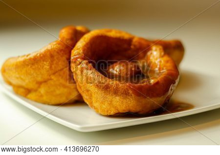 Traditional English Yorkshire Pudding With Meatballs And Thick Gravy Sauce