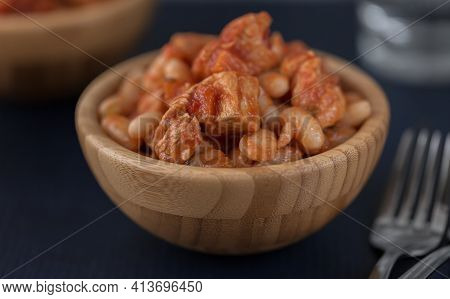 Pork Stew With White Beans In A Wooden Bowl.