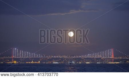 Sea Landscape With Shining City On Background Of Evening Sky With Moon. Action. Beautiful Coast On H