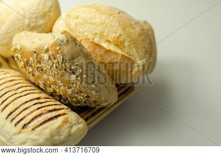 Various Types Of Bread Served On A Wicker Tray, Delicious And Fresh Rolls