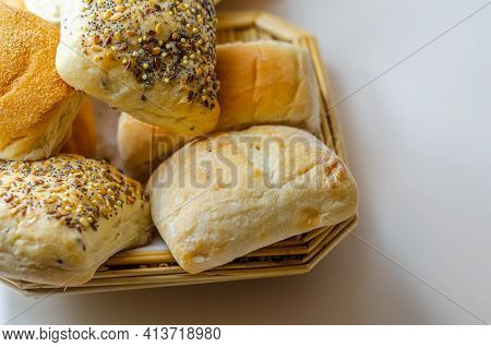 Various Types Of Bread Served On A Wicker Tray, Delicious And Fresh Rolls