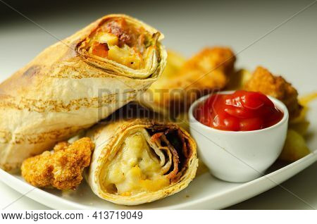 Tortilla Wrap With Chicken And Beechwood Smoked Bacon Served With Chicken Nuggets And Chips On The W