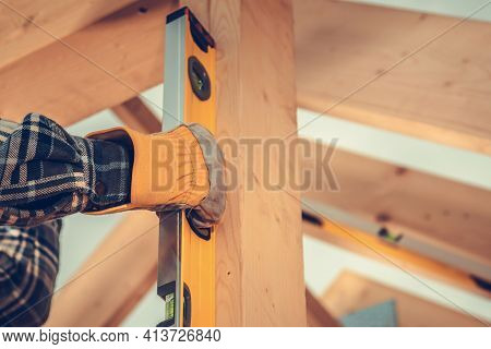 Industrial Theme. Construction Contractor Checking Home Frame Levels Using Sprit Level Tool. Close U