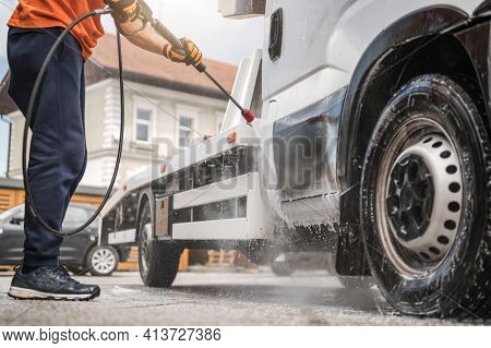 Caucasian Worker In His 40s Power Washing His Commercial Vehicle Towing Truck Inside Manual Car Wash