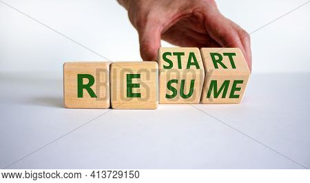 Restart And Resume Symbol. Businessman Turns Cubes And Changes The Word 'restart' To 'resume'. Beaut