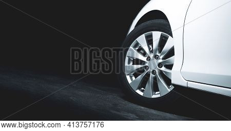 Alloy Wheels Of The White Car Are Turning On The Cement Road Of Parking Lot With Copy Space On The L