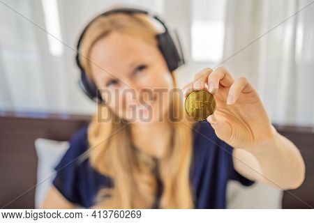 Young Woman, A Digital Artist, Dj Creates Digital Art On A Tablet At Home And Shows A Coin With The 