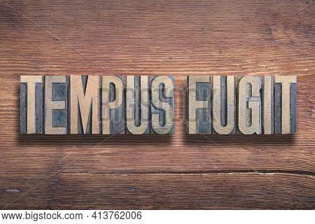 Tempus Fugit Ancient Latin Saying Meaning - Time Flees, Combined On Vintage Varnished Wooden Surface