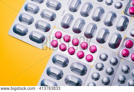 Top View Round Pink Tablets Pills In Blister Packs And Capsule In Silver Aluminium Foil Pack On Yell