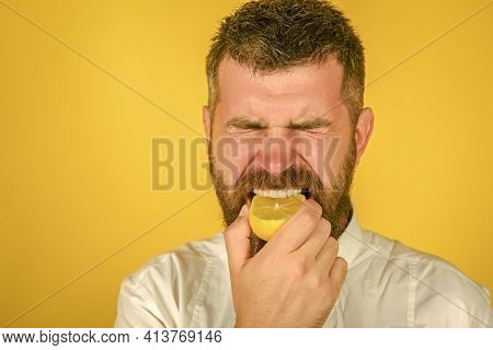 Man Eat Lemon. Fruit And Healthy Organic Food. Fynny Citrus Fruit. A Man Squeezing Lemon Into Mouth