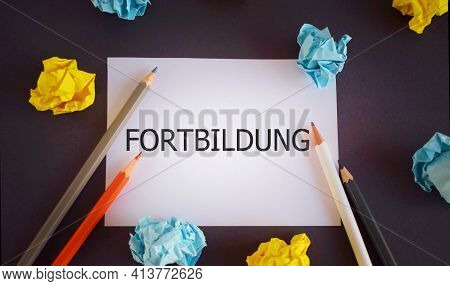 Fortbildung Written On A White Paper . German Language Means Further Education. Pencils And Paper Lo