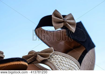 Stock Photo Of Beautiful Pair Of Black And Cream Color High Heel Sandals Displayed On Blur Backgroun