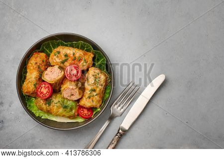 Golubtsi Or Golabki In Black Bowl On Concrete Table Top. Stuffed Cabbage Rolls Dish Of Russian, Poli
