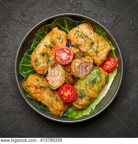 Golubtsi Or Golabki On Black Bowl On Dark Slate Table Top. Stuffed Cabbage Rolls Dish Of Russian, Po