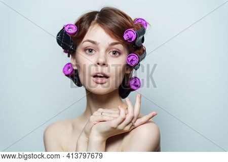 Wind Curls Of Hair Purple Curlers On The Head Of A Red-haired Woman