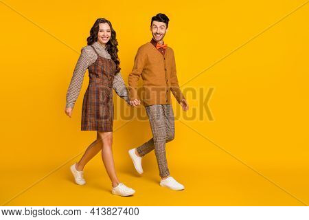 Full Size Photo Of Couple Go Empty Space Hold Hands Wear Plaid Dress Pants Bowtie Sweater Isolated O