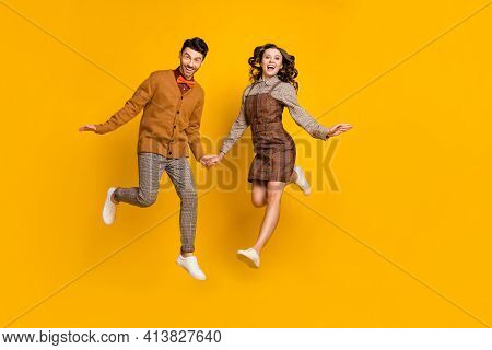 Full Length Photo Of Young Couple Jump Up Excited Active Wear Bowtie Plaid Dress Trousers Isolated O