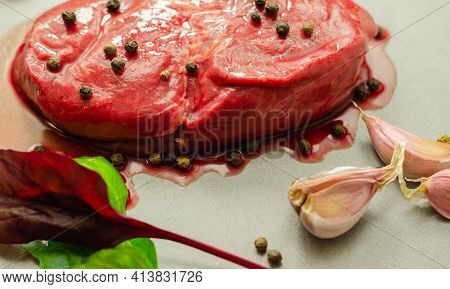 Raw Beef Sirloin Steak With Peppercorns And Garlic Prepared For Frying