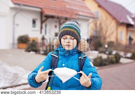 Kid Boy Wearing Ffp Medical Mask On The Way To School. Child Backpack Satchel. Schoolkid On Cold Aut