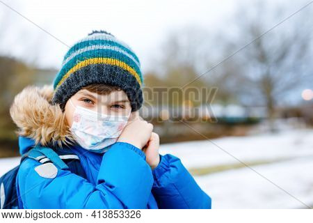 Kid Boy Wearing Ffp Medical Mask On The Way To School. Child Backpack Satchel. Schoolkid On Cold Aut