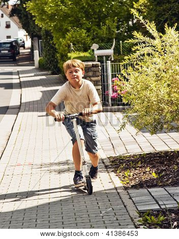 Çocuk Rides Scooter Paveway A Street üzerinde