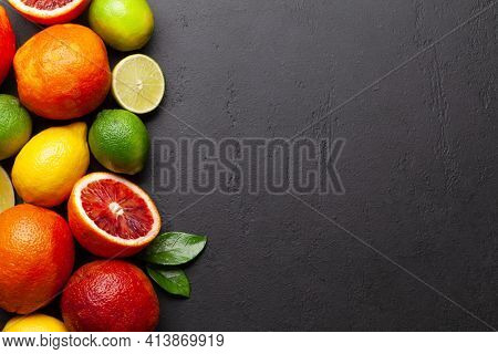 Various fresh citrus fruits. Bood orange, lime, lemon. Top view flat lay with copy space