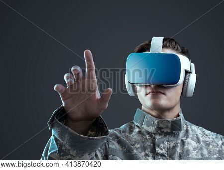 Military in VR headset touching virtual screen